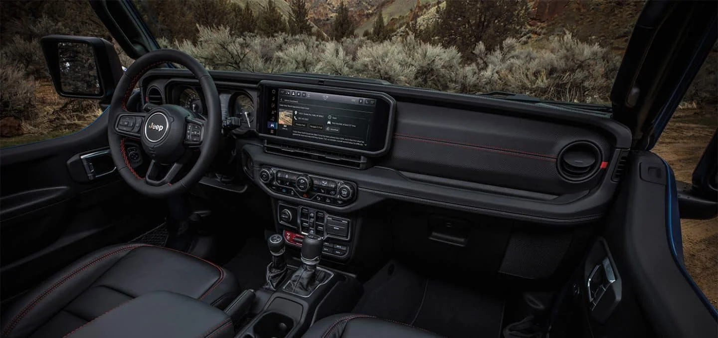 2026 Jeep Wrangler dashboard and infotainment touchscreen with trail map graphics